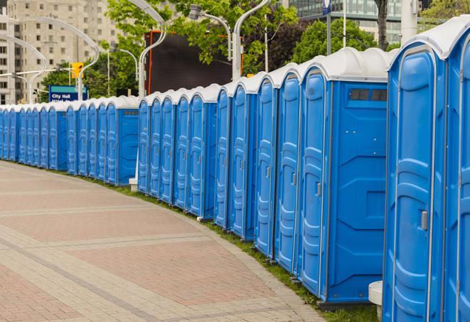 a row of portable restrooms at an outdoor special event, ready for use in Deerfield Beach